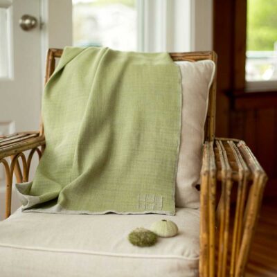 Swans Island Company's Katahdin throw is handwoven in Maine with all natural hand-dyed organic merino wool, Shown here in Thyme.