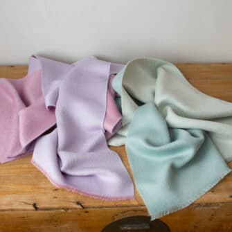 Swans Island Company's Reversible Suri Alpaca Scarf in Aquamarine / Soft Aqua and Soft Pink / Light Purple.