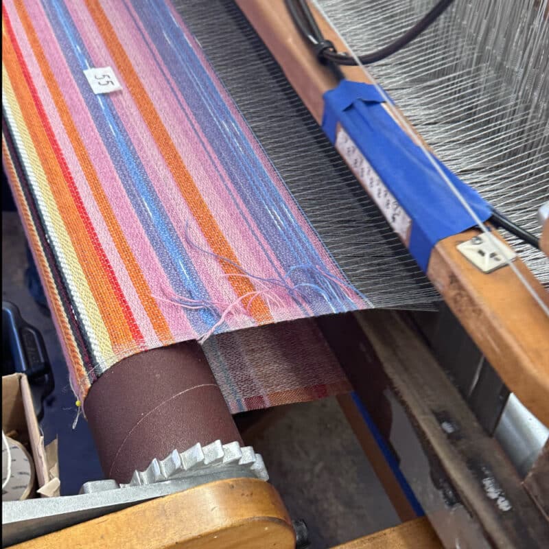 Swans Island Company's Horizon Limited Edition 2026 Throw - A tangible homage to the vibrant colors of first light and golden hour when the sun rises and sets. Handwoven in Maine with hand-dyed wools - a textiles collectors piece. A Horizon throw on the loom.
