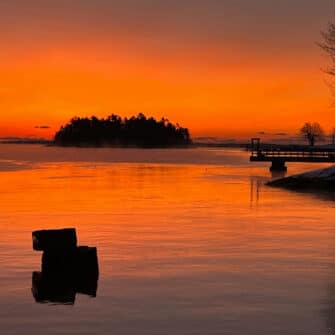 Swans Island Company's Horizon Limited Edition 2026 Throw was inspired by the vibrant colors of sunrise and sunset. A fiery orange sky and water along the Maine coast at sunrise .