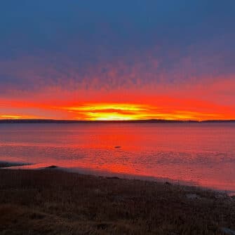 Swans Island Company's Horizon Limited Edition 2026 Throw was inspired by the vibrant colors of sunrise and sunset. A fiery orange water and horizon line as the sun risees along the Maine coast.
