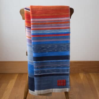 Swans Island Company's Horizon Limited Edition 2026 Throw - A tangible homage to the vibrant colors of first light and golden hour when the sun rises and sets. Handwoven in Maine with hand-dyed wools - a textiles collectors piece.