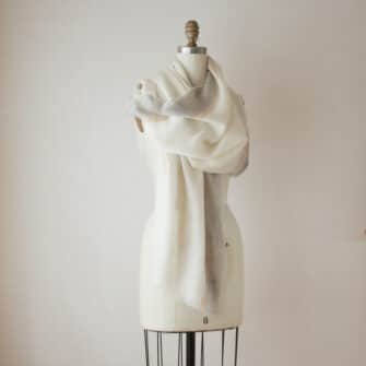 Swans Island Company's Gossamer Alpaca Shawl is whisper thin baby alpaca in undyed natural colors. Shown here in ivory with camel and grey band.