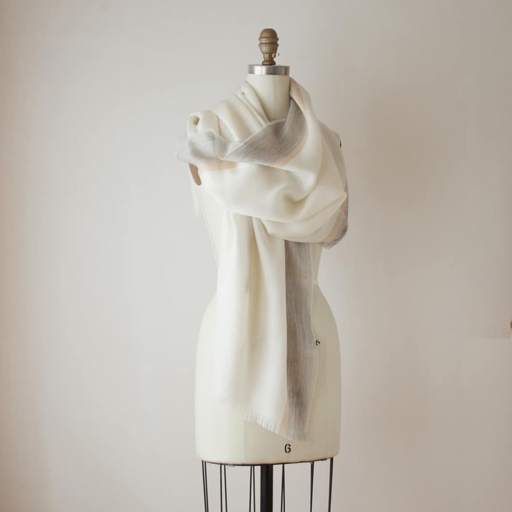 Swans Island Company's Gossamer Alpaca Shawl is whisper thin baby alpaca in undyed natural colors. Shown here in ivory with camel and grey band.