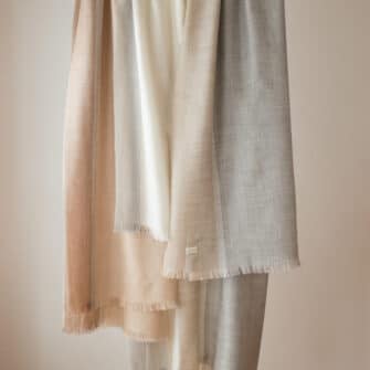 Swans Island Company's Gossamer Alpaca Wrap is whisper thin baby alpaca in undyed natural colors. A trio of soft neutral colors.