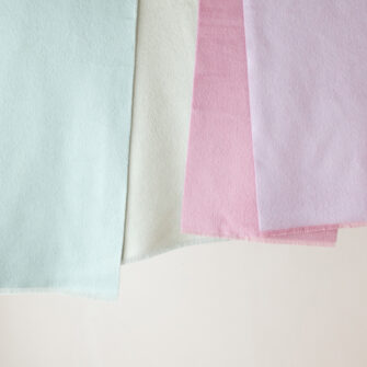 Swans Island Company's Reversible Suri Alpaca Scarf in Aquamarine and Soft Aqua, LightPink and Light Purple. Detail.